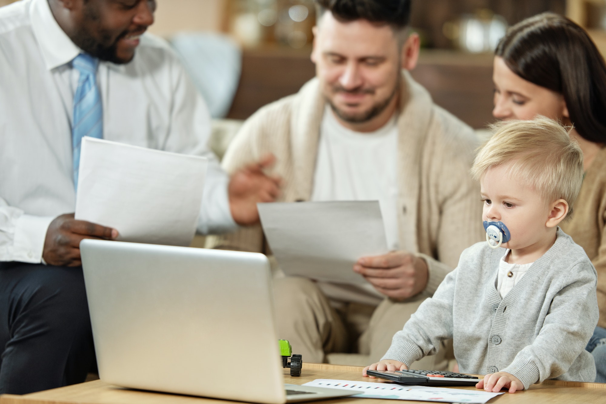 Family with charming boy on meeting with adviser